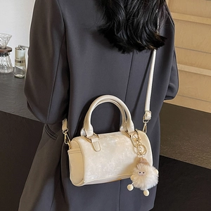 Sac Boston beige chic en forme de barillet avec breloque peluche et bandoulière réglable