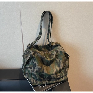 Detail view of durable camouflage canvas tote bag with side pocket and adjustable strap