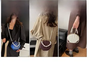 Detail of shell-shaped acrylic evening bag showing hand-held and shoulder-carry styles