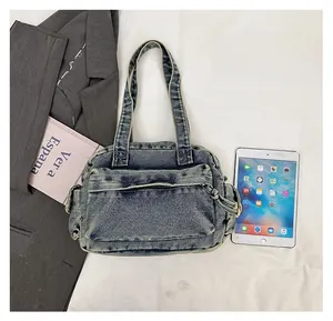 Size comparison of retro denim tote bag with tablet and book on white fabric