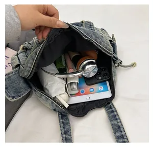 Interior view of denim tote bag showing large capacity for iPad and accessories