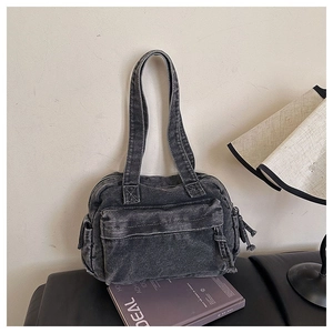 Detail of vintage gray denim tote bag with washed texture and front zipper pocket