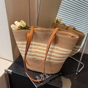 Bohemian woven straw tote bag with beige stripes and long brown leather handles