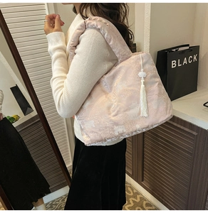 Detail of light pink satin tote bag with traditional Chinese floral embroidery and tassel