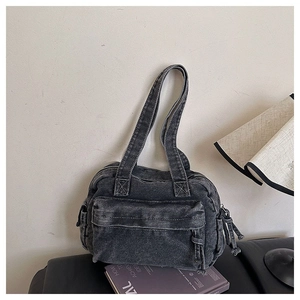 Detail of grey denim tote bag with dual straps and zipper pocket on neutral background