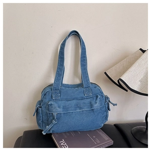 Detailed macro view of retro blue denim tote bag with functional front zipper and side pockets