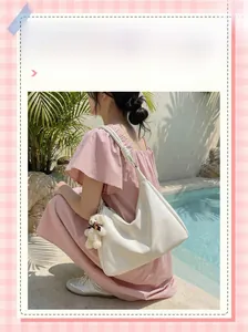 White dumpling shoulder bag with cute bear pendant and knotted strap detail