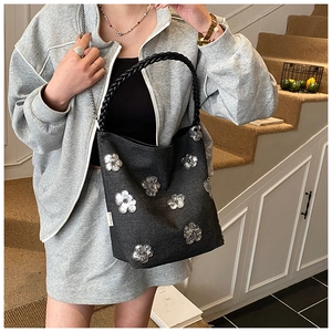 Chic black canvas tote bag with sparkling silver sequin flower patterns and woven handles