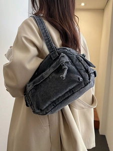 Minimalist black washed denim shoulder bag with functional zipper pocket for women