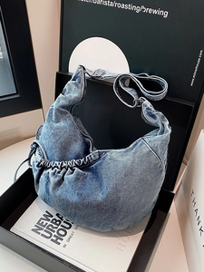 Chic light blue washed denim crescent crossbody bag with adjustable strap in a gift box