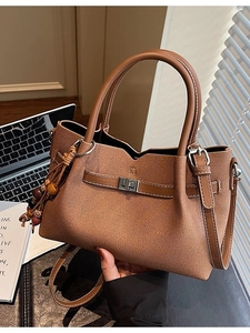 Vintage caramel brown leather tote bag with crossbody strap and ethnic bead detail
