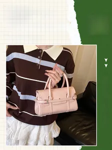 Pink leather handbag detail featuring fine texture paired with a striped polo and skirt
