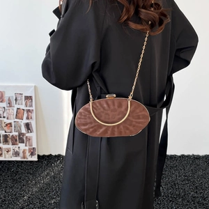 Detailed view of brown leopard pattern crossbody bag with gold metal handle and chain