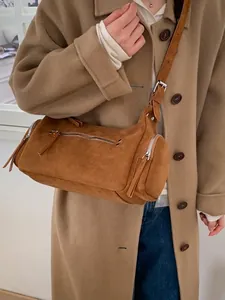 Brown suede cylinder handbag with silver zippers and adjustable strap for women