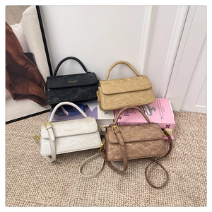 Detail showing the vintage distressed texture and four colors of mini crossbody bags