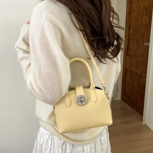 French retro small handbag in pale yellow matte finish with metallic lock and shoulder strap