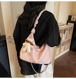 Pink leather Hobo shoulder bag with bear charm and knotted strap detail