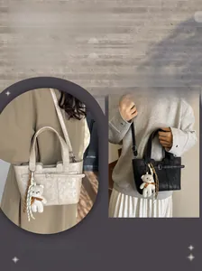 Detail of minimalist bucket bag in cream and black with cute plush bear charms