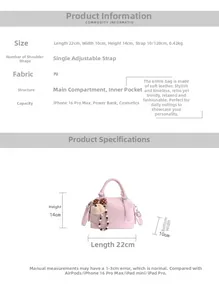 Detail view of pink PU leather tote with bear charm and adjustable shoulder strap