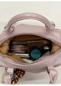 Internal view of a light pink Boston bag showing spacious storage for makeup and phone