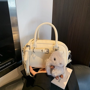 Cream-colored vintage crossbody bag with litchi texture and cute plush rabbit charm