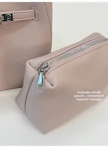 Close-up of pink lychee textured leather bucket bag with matching inner zipper pouch