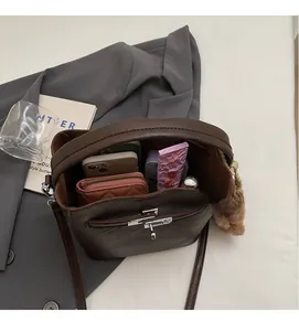Top view of brown leather bucket bag showing spacious interior with daily essentials