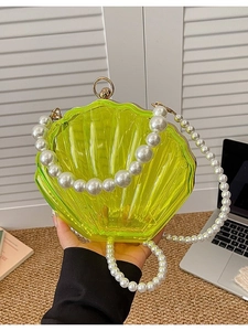 Glossy lime green acrylic shell clutch bag with white pearl handle for elegant evenings