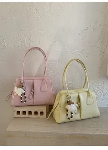 Detailed shot of retro leather shoulder bags with long straps and unique handmade charms
