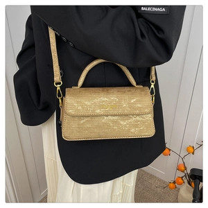 Fashionable gold textured crossbody bag with metal handle and elegant chain strap