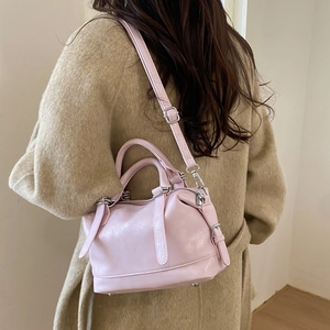 Detail view of pink Boston style PU leather bag with silver hardware and shoulder strap