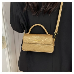 Detail view of champagne gold vintage square bag with metallic texture and strap
