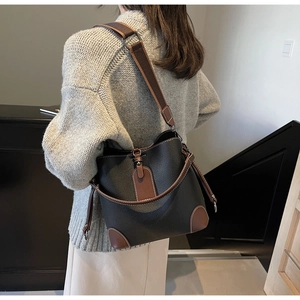 Rear view of model wearing a vintage bucket bag with litchi grain and contrast stitching