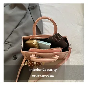 Pink glossy patent leather bag interior capacity showing phone and cosmetics