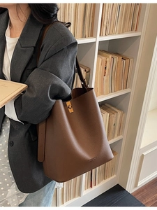 Brown litchi grain leather bucket bag with gold square twist lock and shoulder strap
