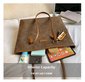 Deep brown tote bag interior capacity showing tablet and daily essentials