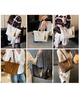 Detail view of large capacity tote bag with tassel charm in beige, brown, and black colors