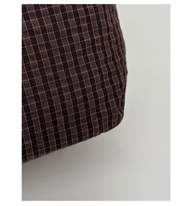 Close-up of durable brown checkered plaid fabric with scratch-resistant texture details