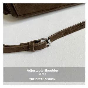 Detail of deep brown frosted tote bag showing adjustable shoulder strap with silver buckle