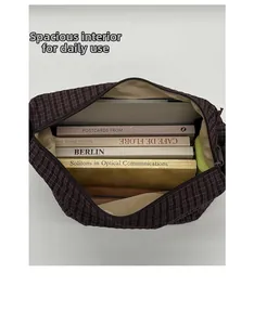 Spacious interior of purple plaid tote bag showing laptop and books storage capacity