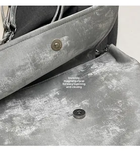 Detail of invisible magnetic clasp on gray textured tote bag for easy closure