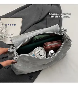 Macro shot of large silver tote bag interior showing ample storage for daily essentials