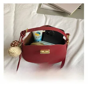 Detail view of the deep red crossbody bag interior showing storage for daily essentials