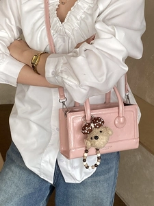 Pink patent leather rectangular bag with heart embossing and cute bear charm pendant