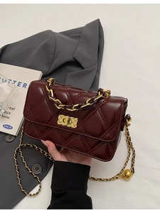 Burgundy quilted chain flap bag in glossy leather with gold lock and metal strap