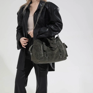 Detail of dark olive green messenger bag with metallic buckles and tactical straps