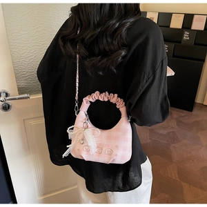 Detail of pink plaid hobo bag with bear embroidery and lace pearl bow charm