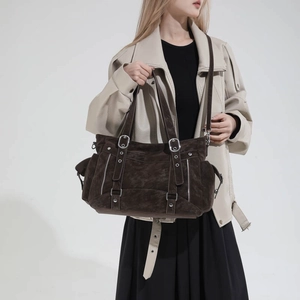 Close-up of retro large-capacity tote bag with silver buckles and suede texture