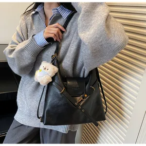 Vue détaillée du sac cabas vintage noir avec breloque ours et boucle métallique