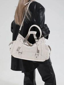 Chic off-white leather tote bag with functional metal buckles and adjustable strap